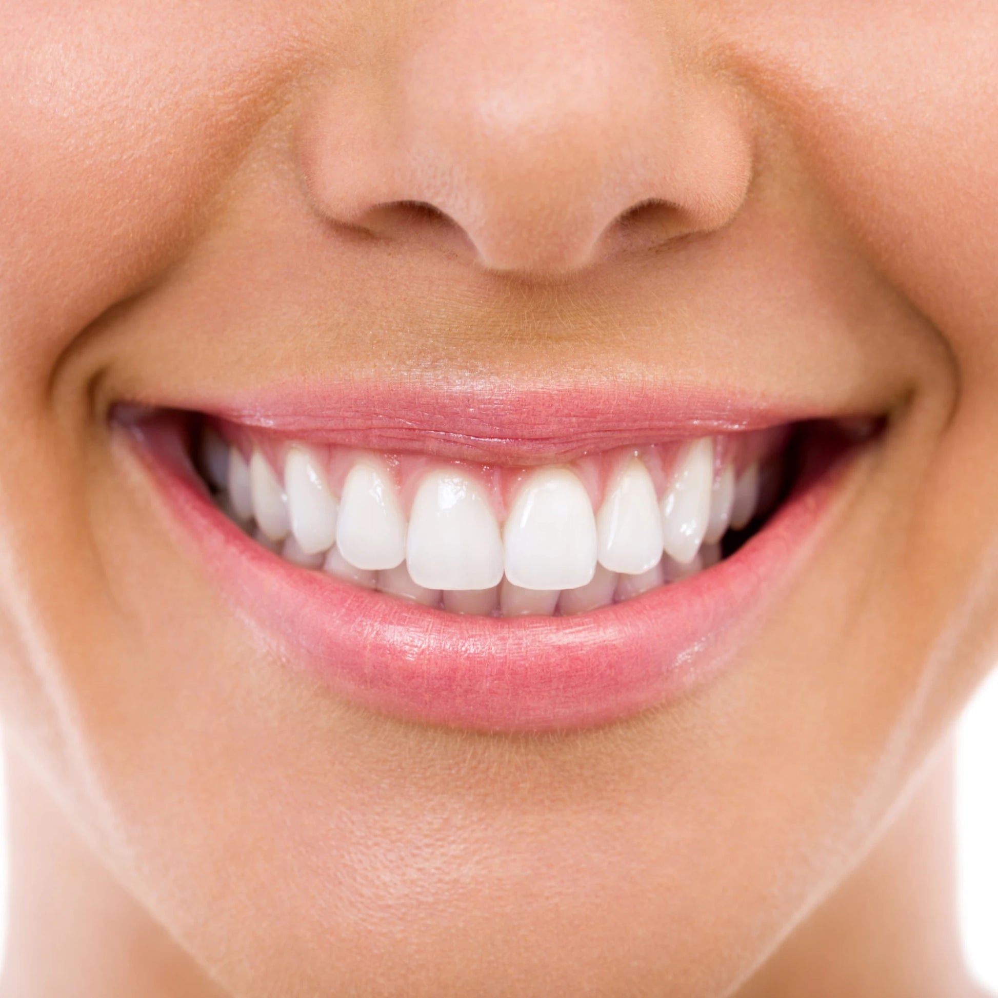 Close-up of a person's smiling mouth with white teeth